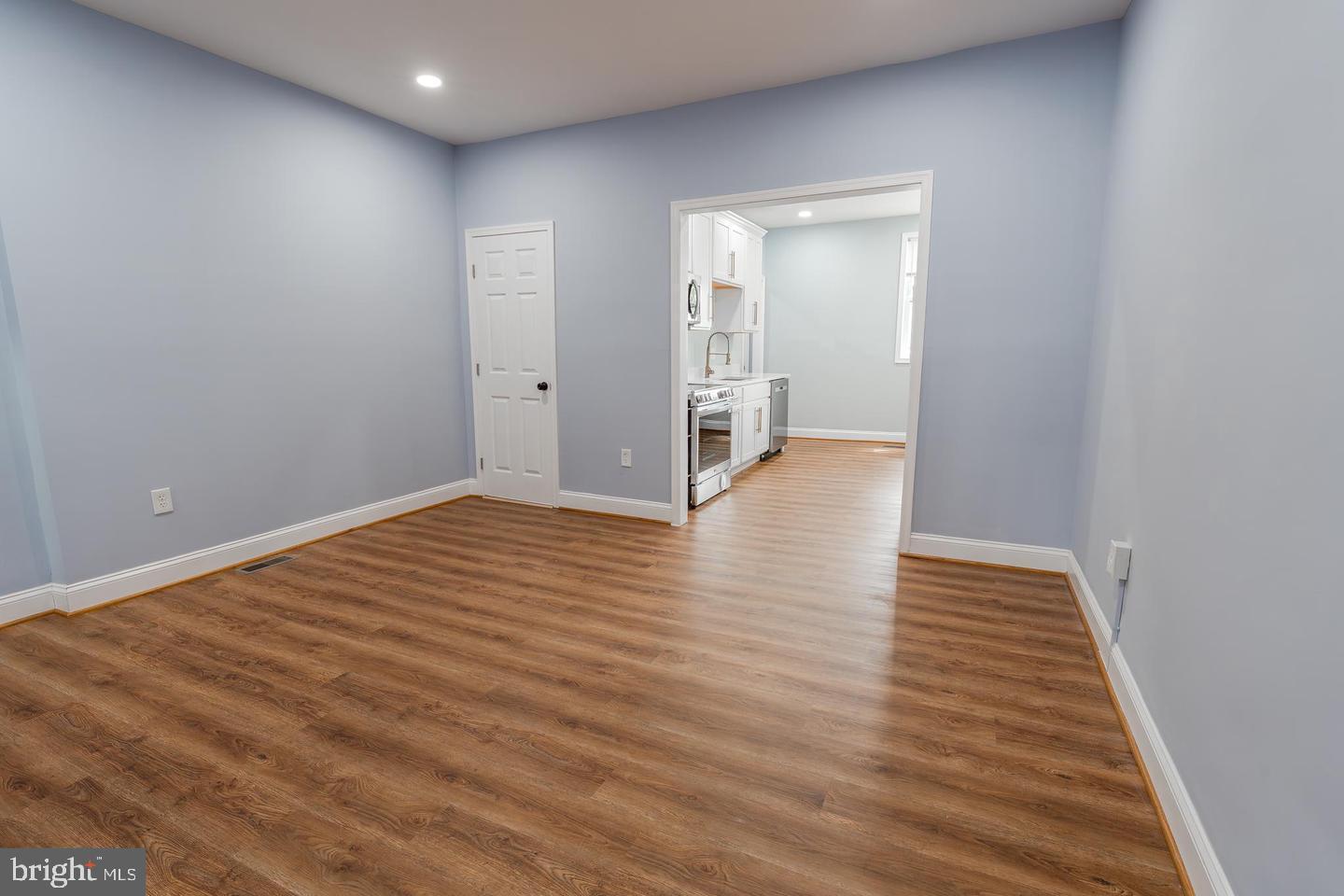 3211 Baker Street Baltimore, MD 21216 - Photo 8 of 20 a view of an empty room with wooden floor
