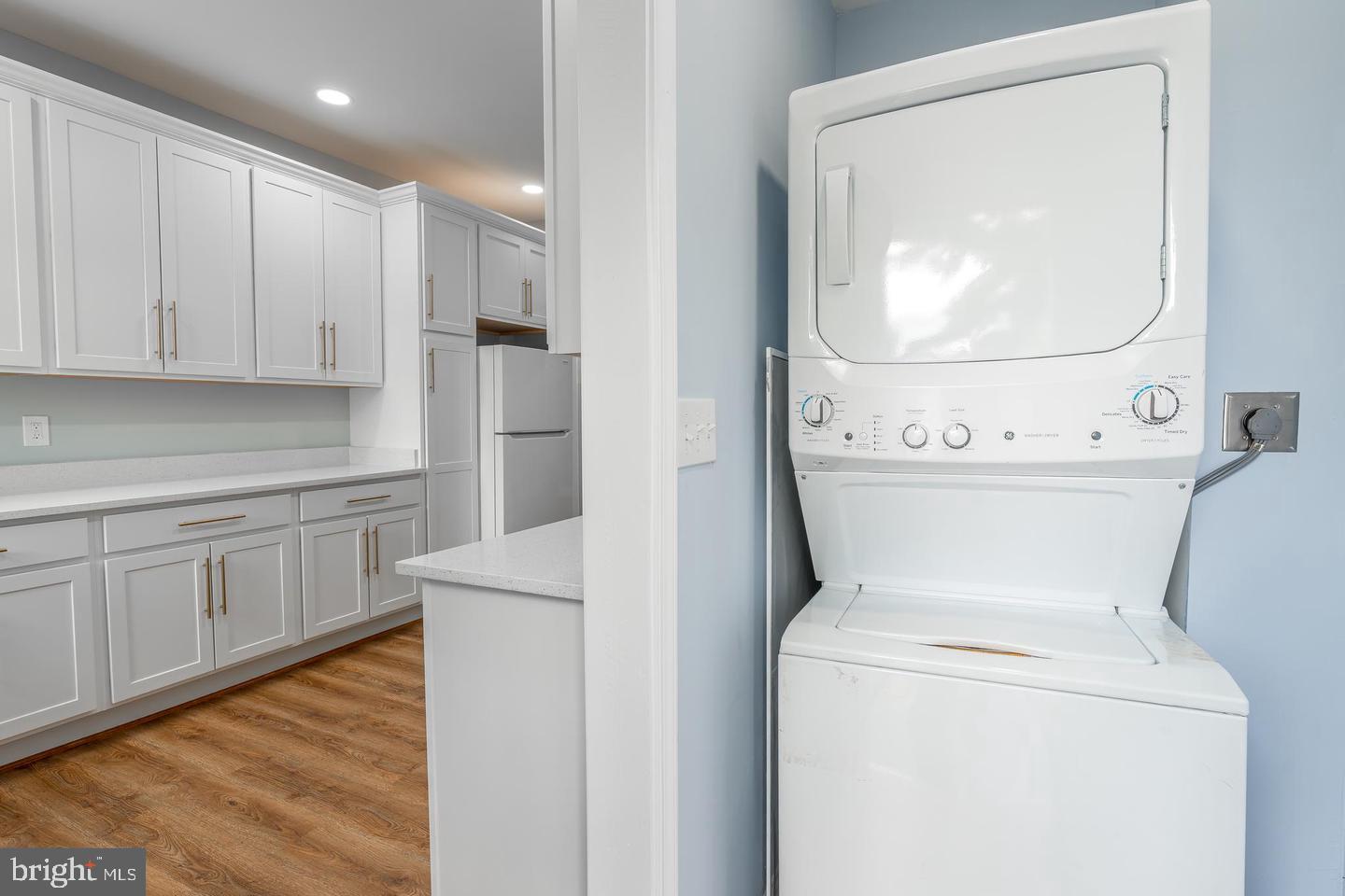 3211 Baker Street Baltimore, MD 21216 - Photo 9 of 20 a view of washer and dryer with kitchen in the background