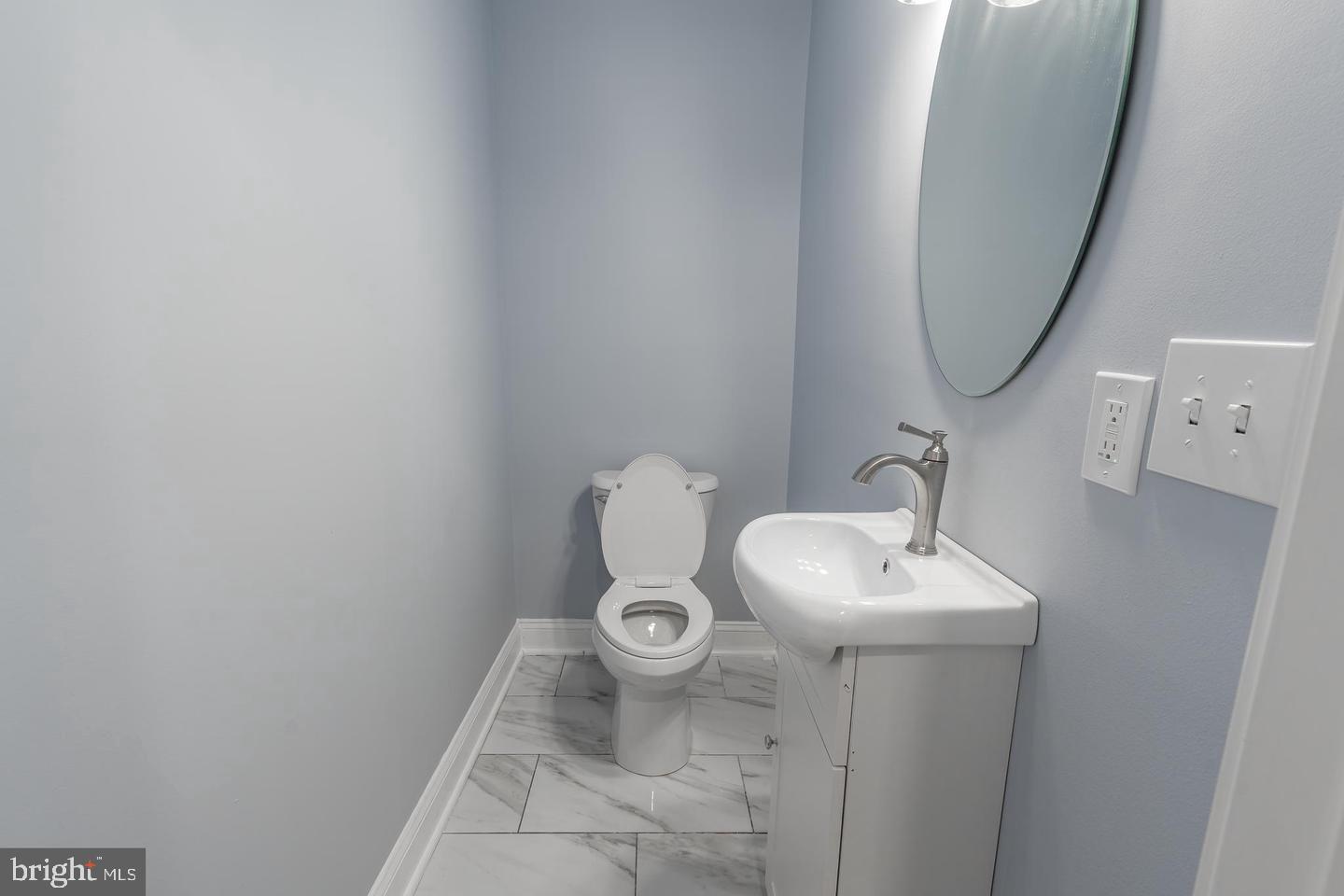 3211 Baker Street Baltimore, MD 21216 - Photo 10 of 20 a bathroom with a sink and a mirror
