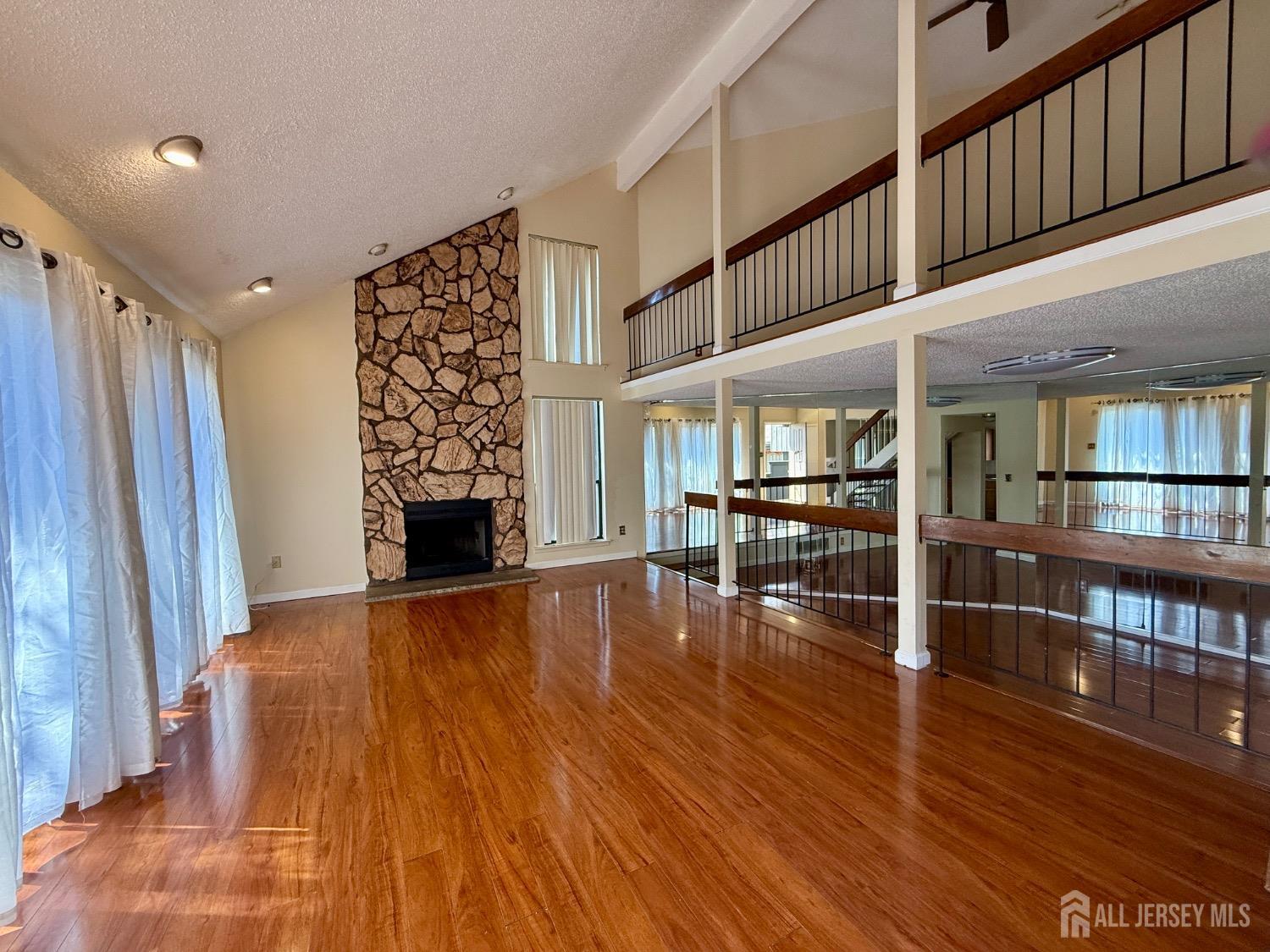 136 Westgate Drive Edison, NJ 08820 - Photo 3 of 17 a view of empty room with wooden floor and fireplace