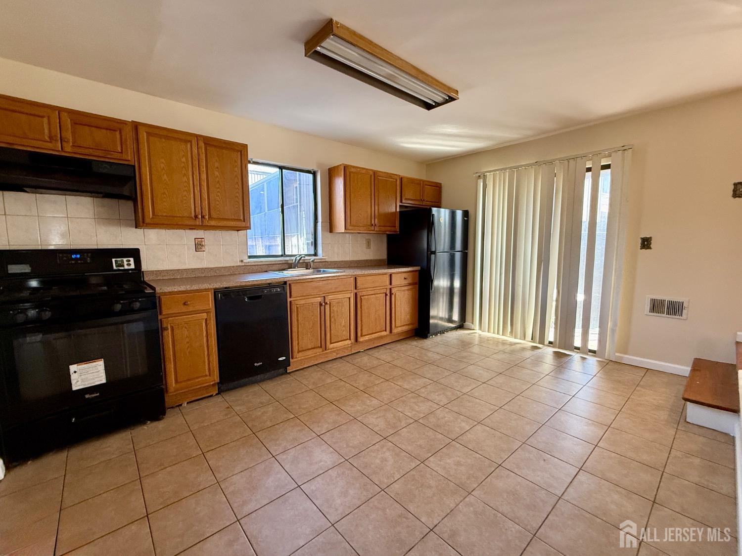 136 Westgate Drive Edison, NJ 08820 - Photo 5 of 17 a kitchen with stainless steel appliances granite countertop a stove sink and cabinets