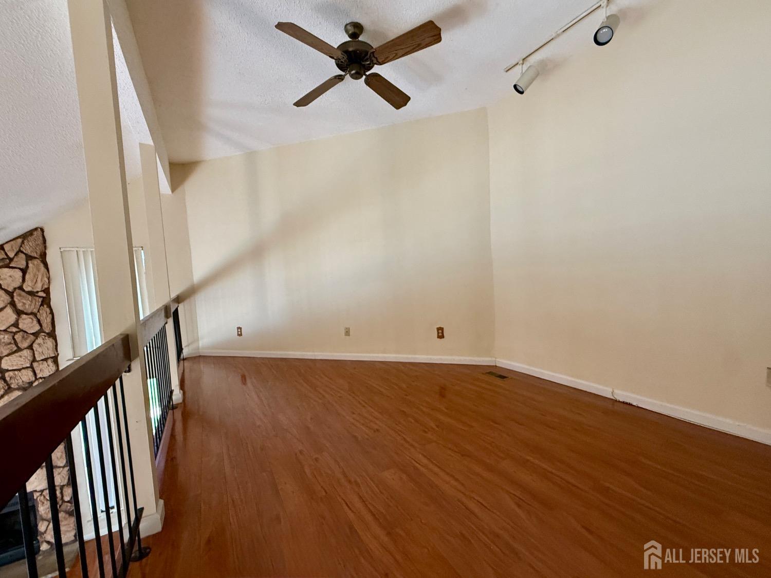 136 Westgate Drive Edison, NJ 08820 - Photo 10 of 17 a view of a big room with wooden floor and windows
