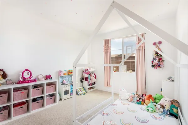 a bedroom with furniture and a book shelf