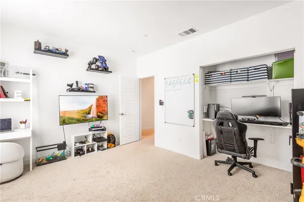 a view of a workspace with furniture and a bedroom