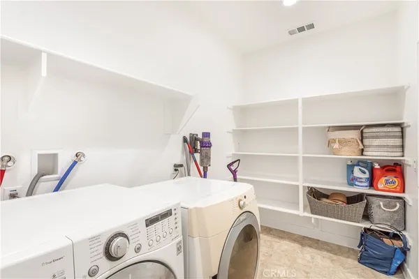 a utility room with dryer washer and closet