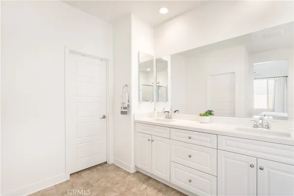 a bathroom with a double vanity sink and mirror
