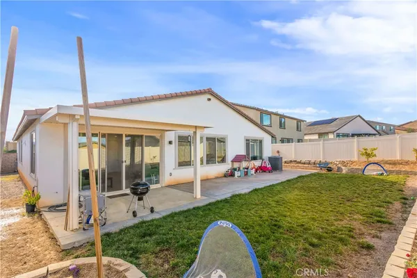 a view of a house with backyard porch and furniture