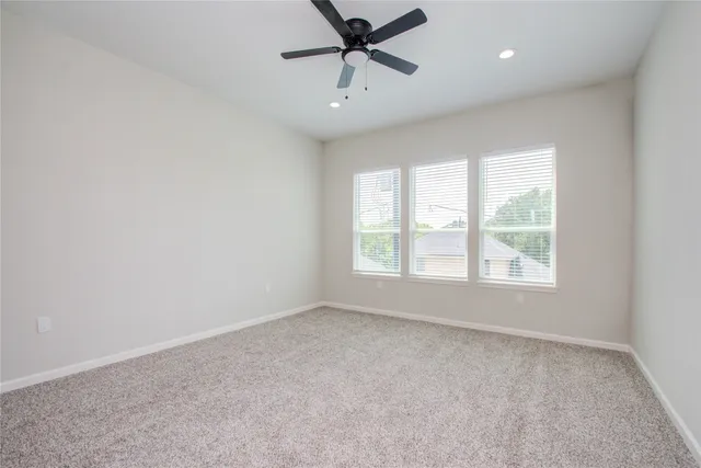 a view of a livingroom with a ceiling fan and window