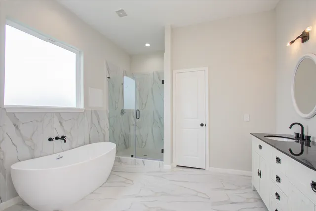a spacious bathroom with a bathtub and shower
