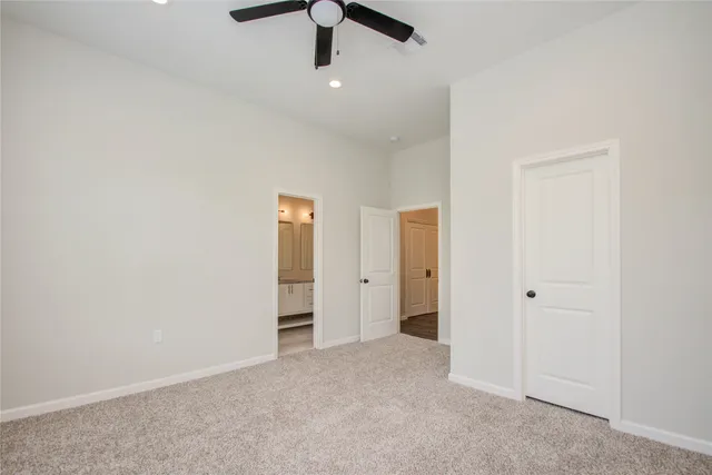 an empty room with chandelier fan