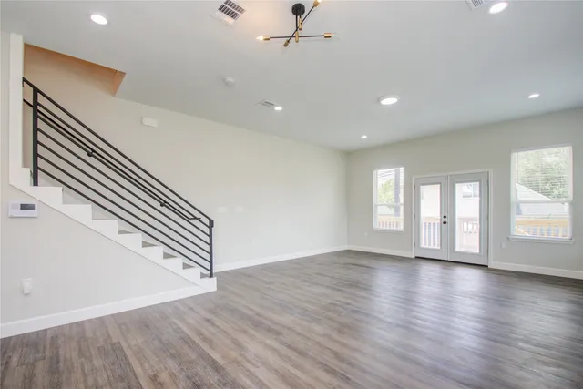 wooden floor in an empty room with a window
