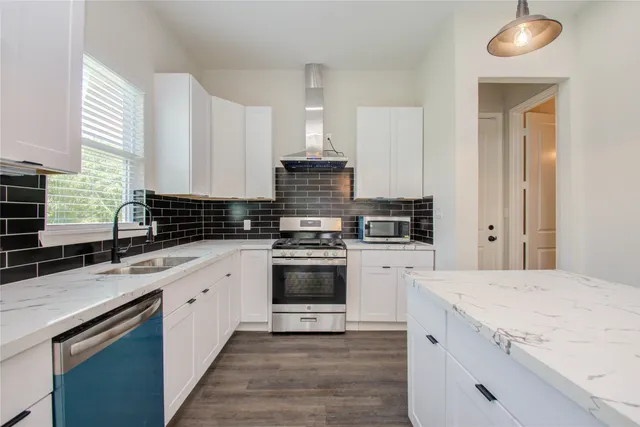 a kitchen with a stove and a sink