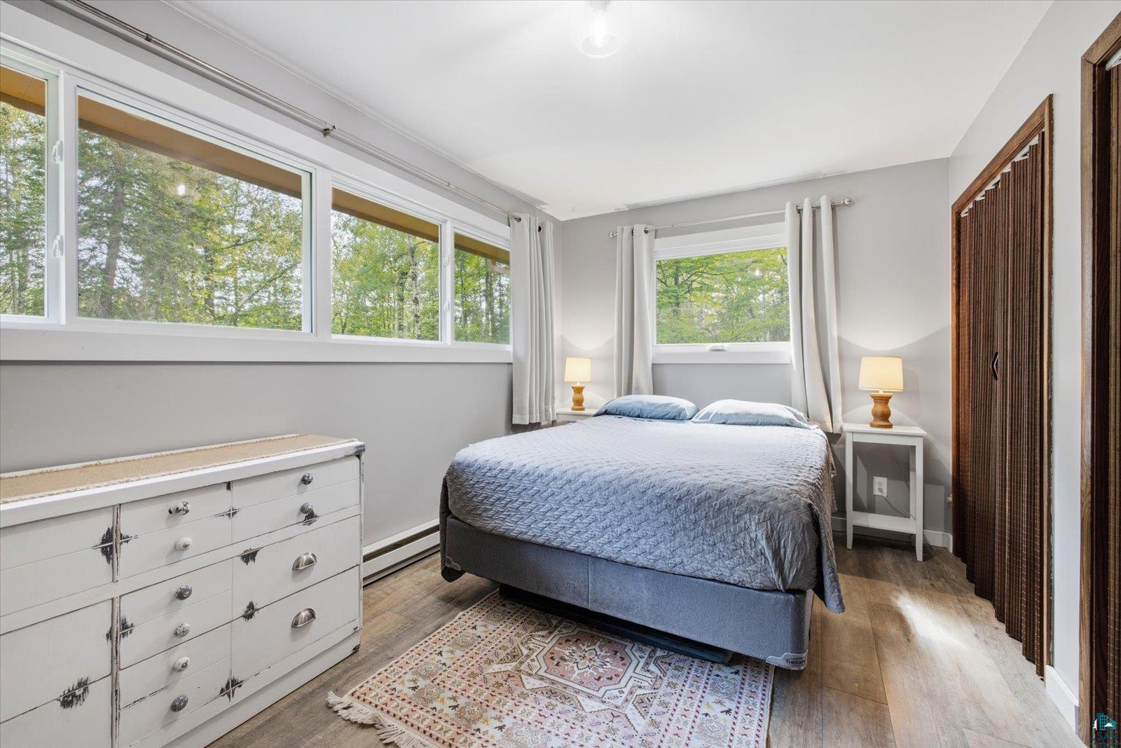 6377 Bergstrom Road Saginaw, MN 55779 - Photo 13 of 20 Bedroom featuring wide plank wood-finish flooring, light grey wall paint, and white trim