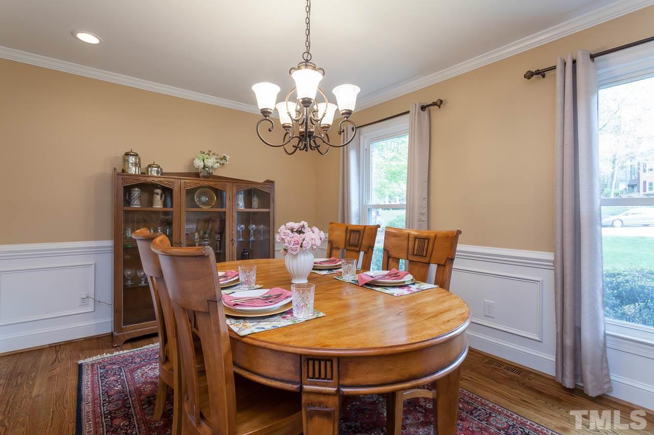 8805 Bickley Place Raleigh, NC 27613 - Photo 8 of 25 a view of a dining room with furniture window and wooden floor