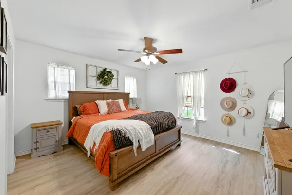 a bedroom with a bed and wooden floor