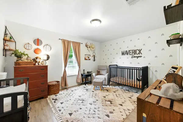 a bathroom with a granite countertop sink a mirror and a toilet