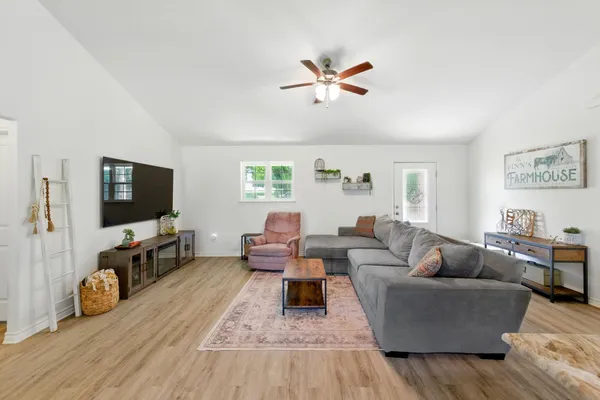 a living room with furniture and a flat screen tv