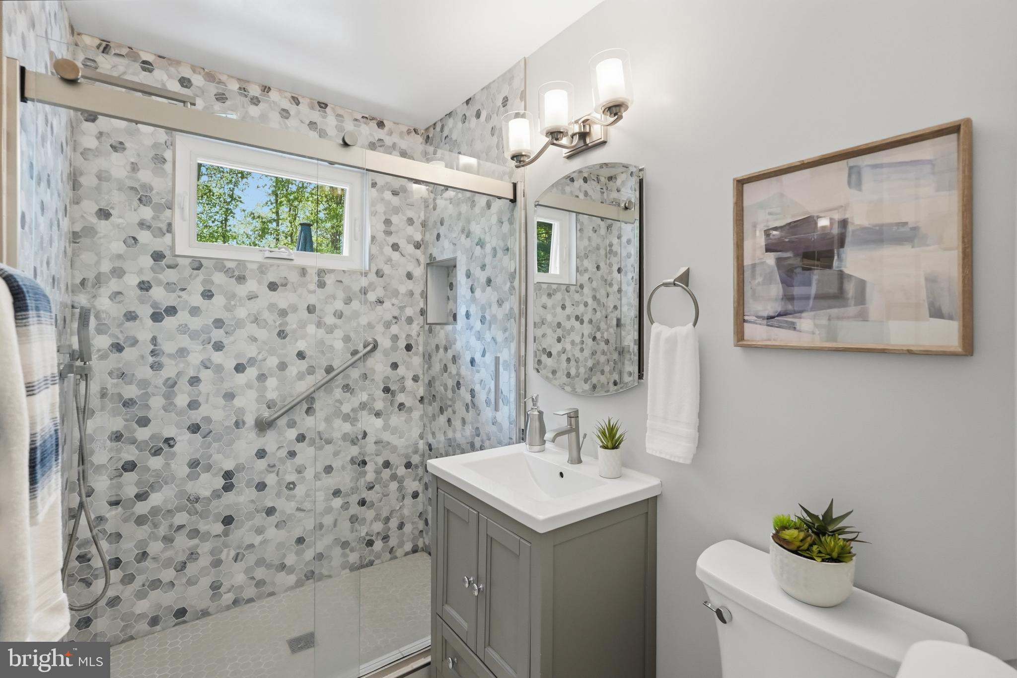 7006 Barnack Drive Springfield, VA 22152 - Photo 26 of 56 a bathroom with a sink a vanity and a mirror