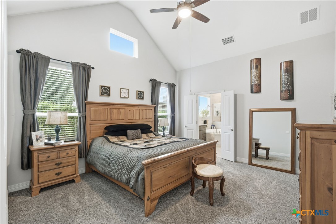 1209 Winding Way Drive Georgetown, TX 78628 - Photo 14 of 37 a bedroom with furniture and a fireplace