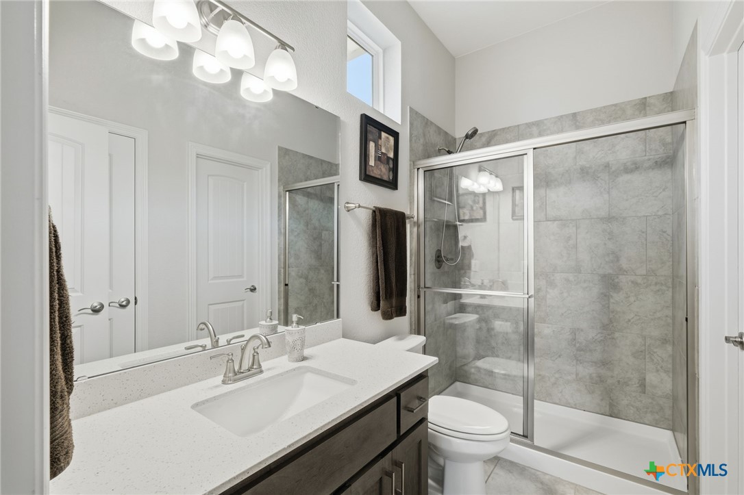 1209 Winding Way Drive Georgetown, TX 78628 - Photo 17 of 37 a bathroom with a sink a toilet and shower