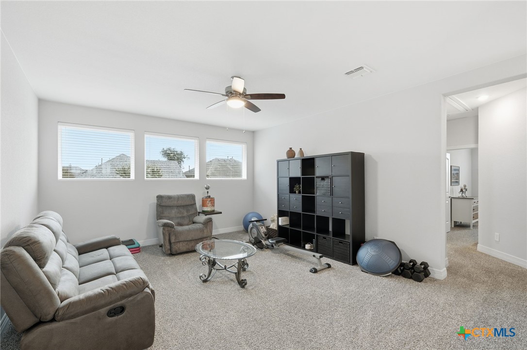 1209 Winding Way Drive Georgetown, TX 78628 - Photo 18 of 37 a living room with furniture and a window