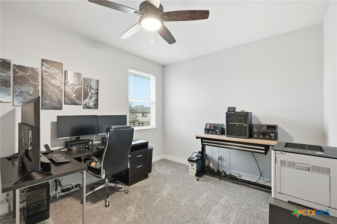 1209 Winding Way Drive Georgetown, TX 78628 - Photo 21 of 37 a view of a workspace with furniture and a window