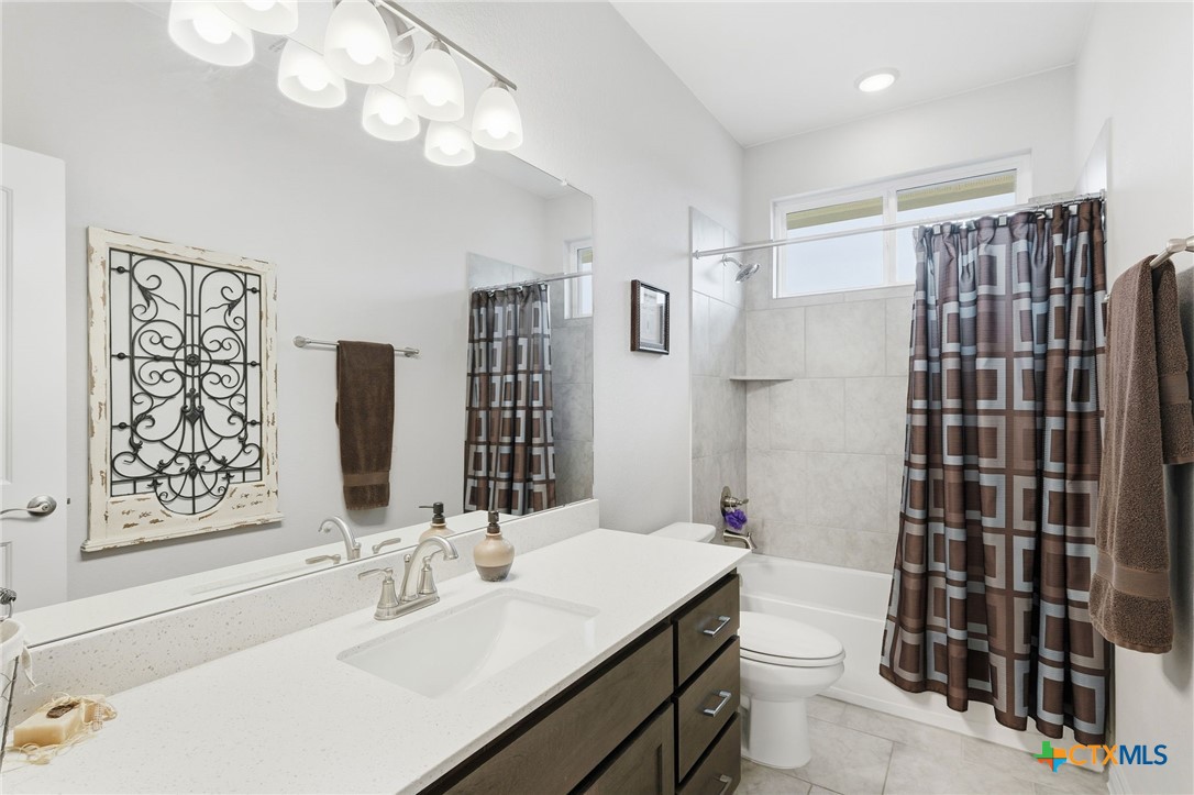 1209 Winding Way Drive Georgetown, TX 78628 - Photo 22 of 37 a bathroom with a sink toilet and shower