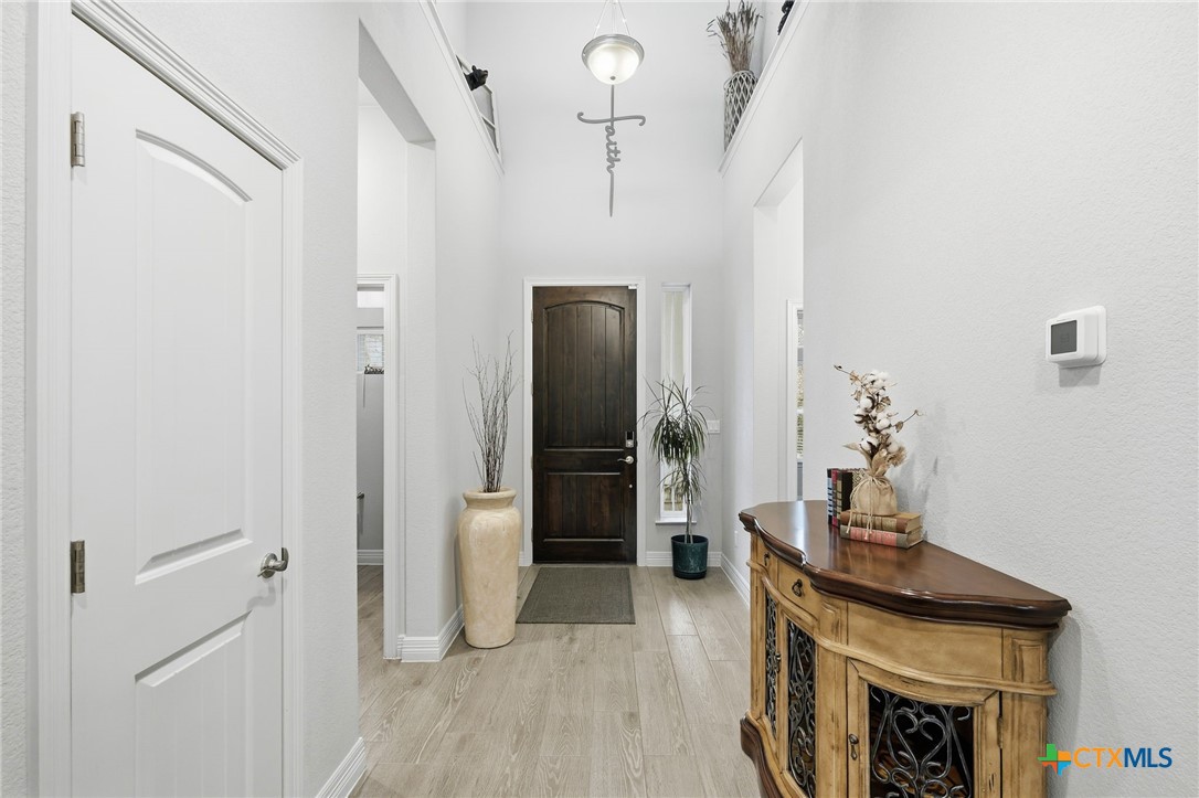 1209 Winding Way Drive Georgetown, TX 78628 - Photo 6 of 37 a hallway with a stove and a mirror