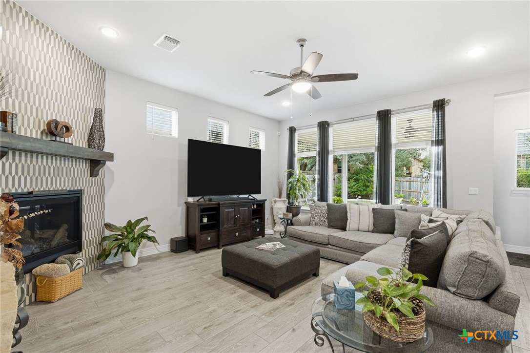 1209 Winding Way Drive Georgetown, TX 78628 - Photo 7 of 37 a living room with fireplace furniture and a flat screen tv