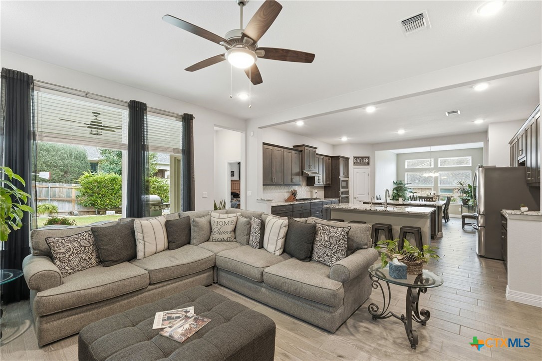 1209 Winding Way Drive Georgetown, TX 78628 - Photo 9 of 37 a living room with furniture kitchen area and a large window