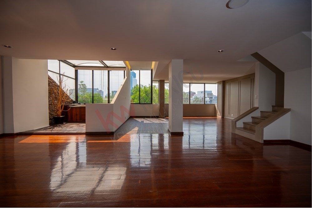 150 Viaducto Rio Becerra, Unit PH Alton Bay, CDMX 03810 - Photo 1 of 33 a living room with hardwood floor and large windows