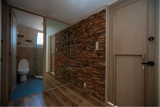 a bathroom with a shower and a toilet