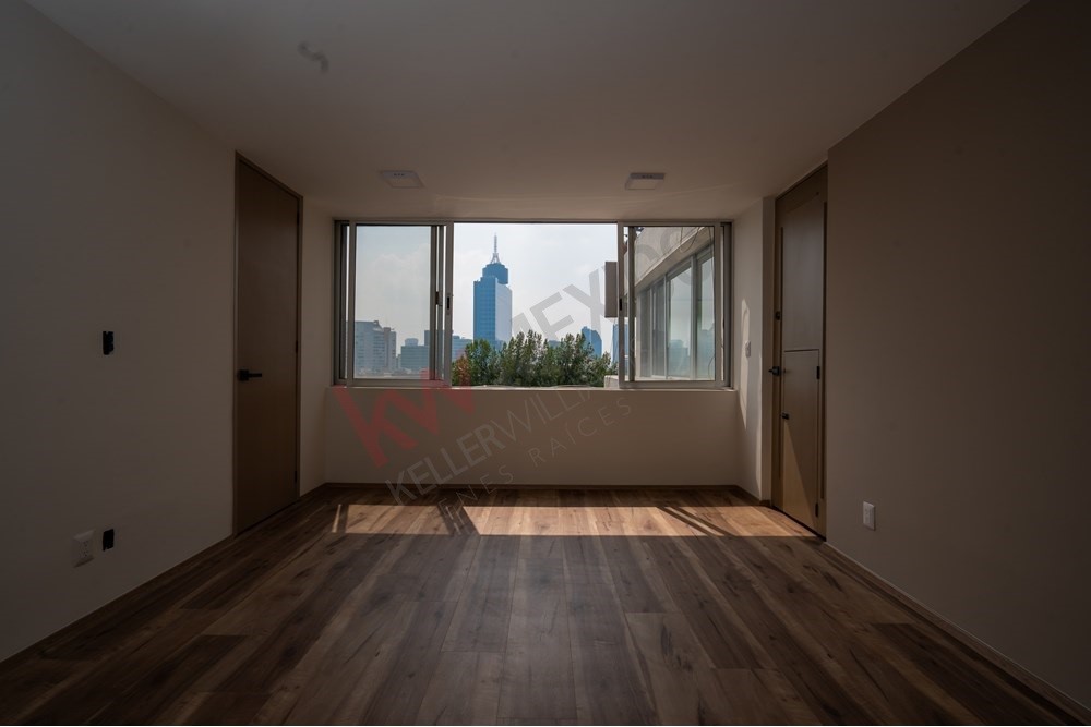 150 Viaducto Rio Becerra, Unit PH Alton Bay, CDMX 03810 - Photo 20 of 33 an empty room with wooden floor and windows