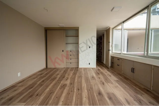 a view of a room with wooden floor and cabinet