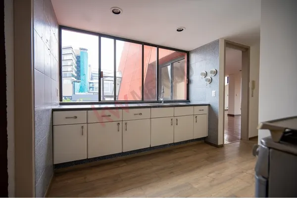 a large white room with a large window and furniture