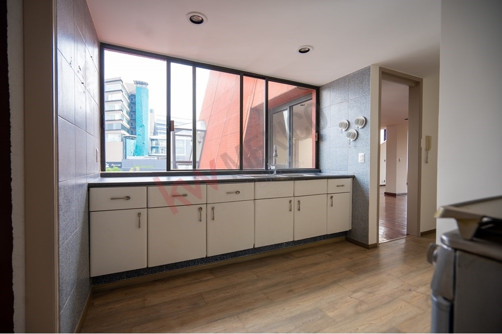 150 Viaducto Rio Becerra, Unit PH Alton Bay, CDMX 03810 - Photo 27 of 33 a large white room with a large window and furniture