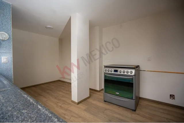 a large room with a large window and wooden floor