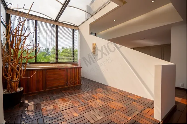 a view of a porch with wooden floor and furniture