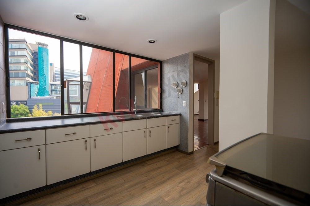 150 Viaducto Rio Becerra, Unit PH Alton Bay, CDMX 03810 - Photo 31 of 33 a large room with a large window and wooden floor