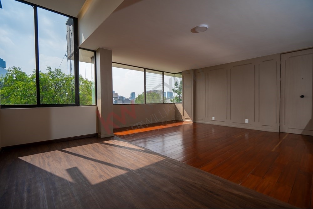 150 Viaducto Rio Becerra, Unit PH Alton Bay, CDMX 03810 - Photo 6 of 33 a view of an empty room with wooden floor and a window