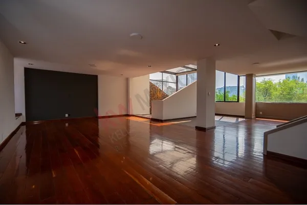 a view of a living room with hardwood floor and large windows