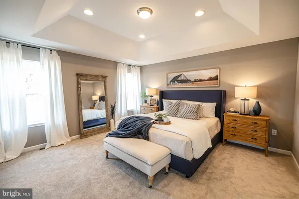 a spacious bedroom with a bed and walk in closet