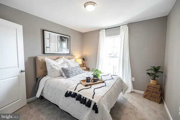 a bedroom with bed and a window