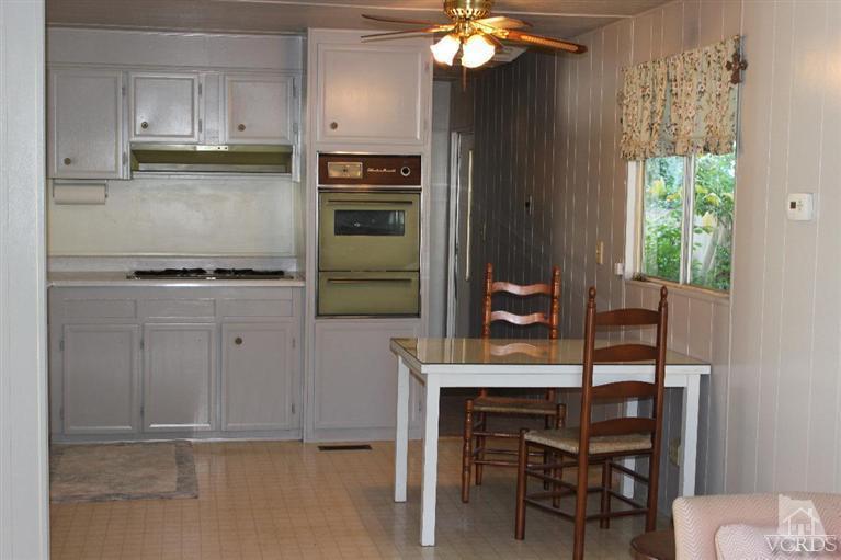 1225 South Rice Road, Unit 35 Ojai, CA 93023 - Photo 14 of 19 a kitchen with kitchen island a counter space a sink appliances and cabinets