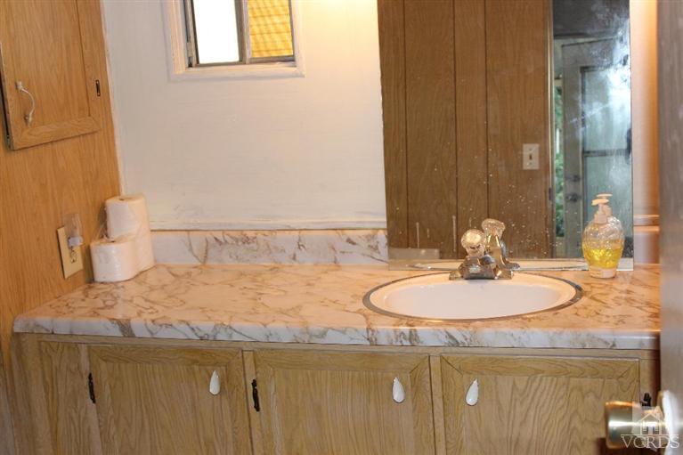 1225 South Rice Road, Unit 35 Ojai, CA 93023 - Photo 17 of 19 a bathroom with a granite countertop sink and a mirror