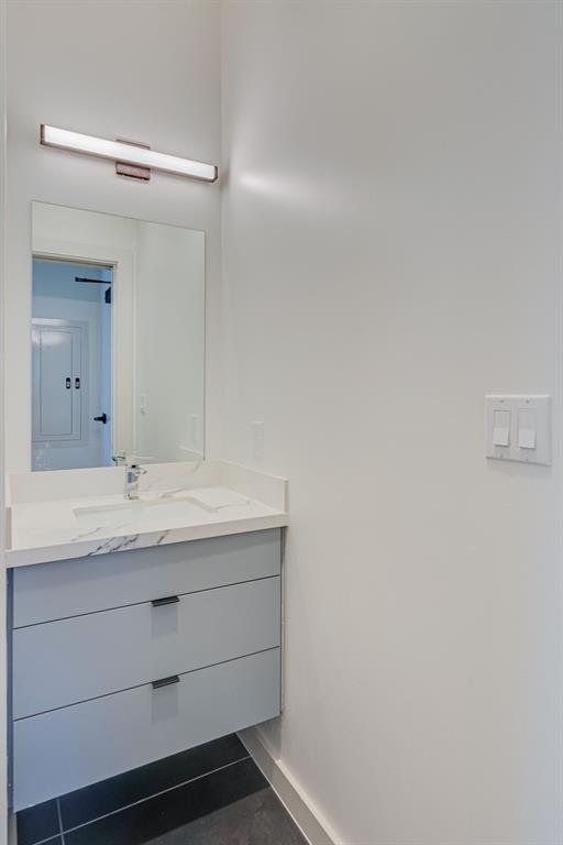 1023 Lipscomb Street, Unit 302 Fort Worth, TX 76104 - Photo 12 of 30 a bathroom with a granite countertop sink and a mirror