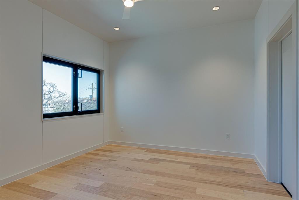 1023 Lipscomb Street, Unit 302 Fort Worth, TX 76104 - Photo 13 of 30 an empty room with wooden floor and windows