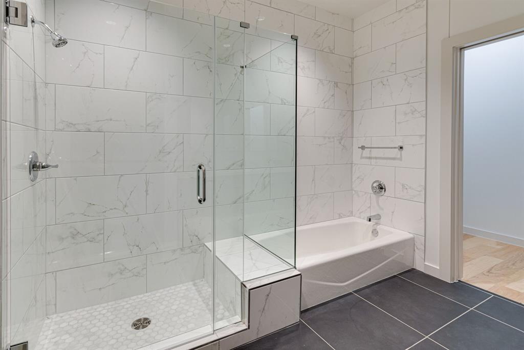 1023 Lipscomb Street, Unit 302 Fort Worth, TX 76104 - Photo 16 of 30 a bathroom with a bathtub and a shower