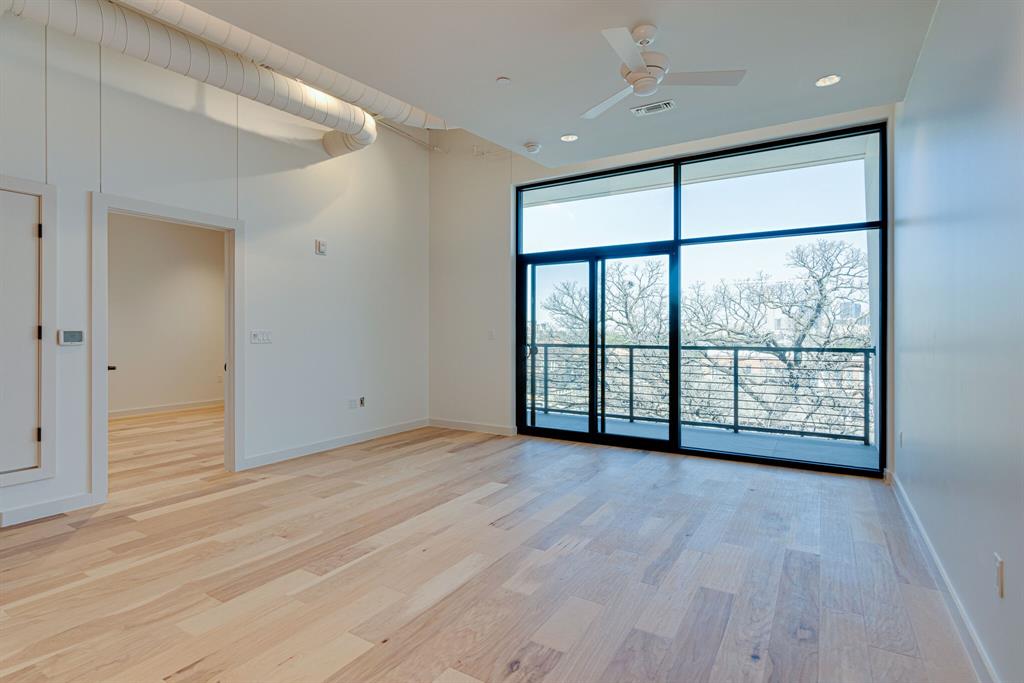 1023 Lipscomb Street, Unit 302 Fort Worth, TX 76104 - Photo 23 of 30 wooden floor in an empty room with a window