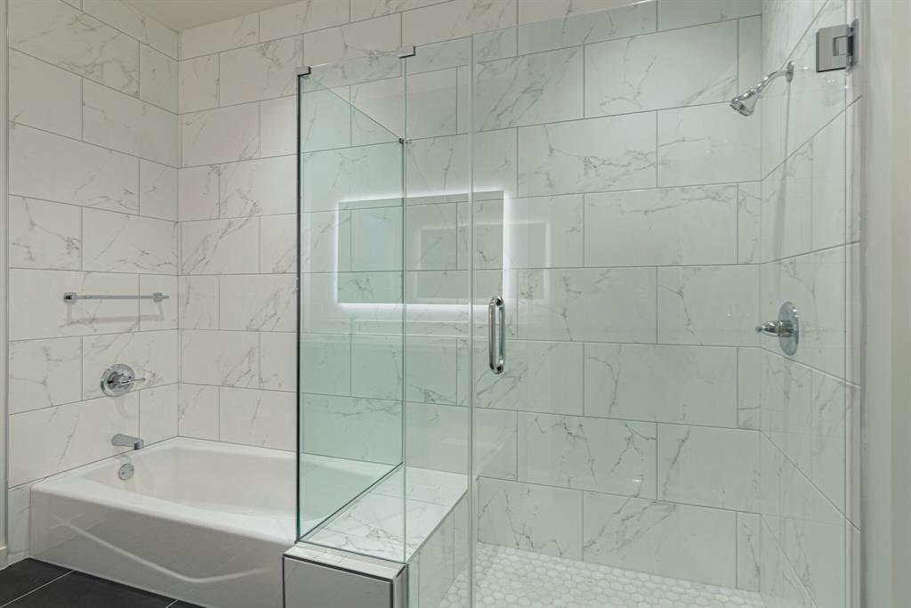 1023 Lipscomb Street, Unit 302 Fort Worth, TX 76104 - Photo 28 of 30 a bathroom with a bathtub and shower